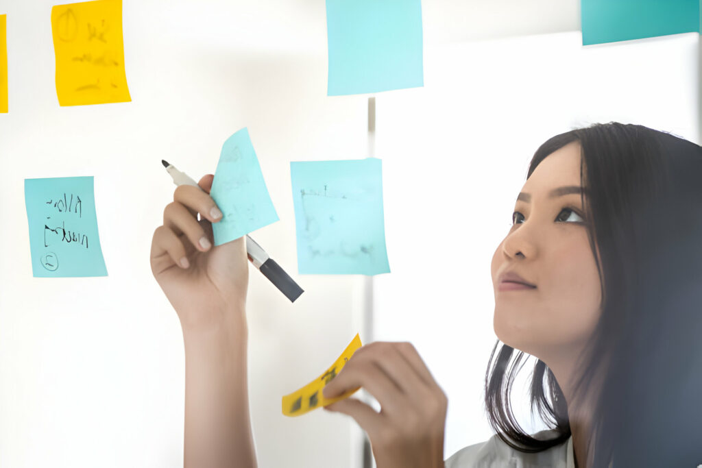 Young female adult pasting sticky note